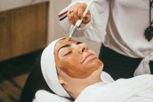 face mask application by a beauty therapist on a woman 