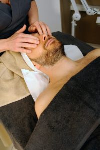 a man getting facial skincare from a spa 